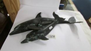 A bronze dolphin wall plaque.
