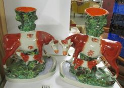 A pair of Staffordshire cow with calf spill vases.