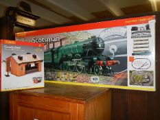 A boxed new Hornby Flying Scotsman 00 train set and a boxed Hornby goods shed, COLLECT ONLY.