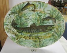 An oval platter decorated with pike by House of Stewart, 40 cm x 31 cm.