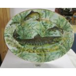 An oval platter decorated with pike by House of Stewart, 40 cm x 31 cm.