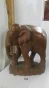 A carved wood elephant. COLLECT ONLY.