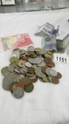 A mixed lot of mainly foreign coins and bank notes including Queen Mother £5 coin.