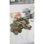 A mixed lot of mainly foreign coins and bank notes including Queen Mother £5 coin.