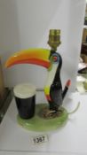 A Carlton ware toucan table lamp (a/f, beak glued back on) 21.5 cm tall.