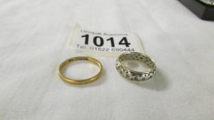 A 22ct gold wedding ring, size L, 2.1 grams and a 9ct gold eternity ring size L.