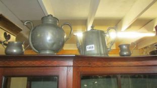 An unusual pewter teapot, another teapot, a sugar bowl and a cream jug.