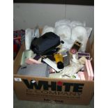 A box full of complimentary items from hotels including slippers, shampoo, conditioner, cotton