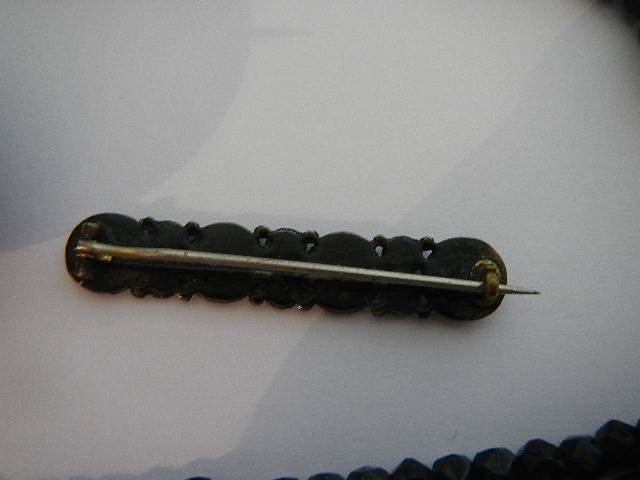 Two black Whitby jet style brooches and a black necklace. - Image 4 of 5