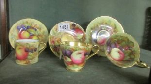 Three Aynsley orchard gold tea cups and saucers.