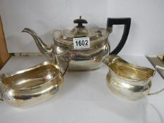 A three piece silver tea set, Birmingham, Barker Bros, approximately 29 ounces.