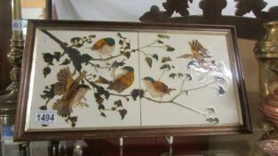 Two framed bird decorated tiles.