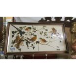 Two framed bird decorated tiles.