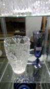 A heavy cut glass vase, 26 cm and a blue glass vase, 30 cm.
