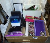 A large box of assorted costume jewellery including silver