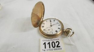 A gold plated full hunter pocket watch marked Dennison Watch Case Co., Ltd., In working order.