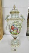 A lidded hand painted 19th century urn decorated with exotic bird, gold anchor mark to base, 38cm.