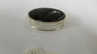 A silver pill box by David Scott Walker, Sheffield with jewelled/stone top.