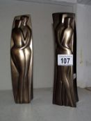 A pair of modern candle holders