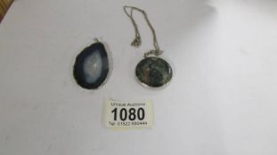 A moss agate pendant in silver with attached silver chain together with a pendant in silver mount.