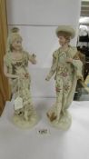 A good pair of Continental porcelain figures, 34 cm tall. (Something missing from the man's hand).