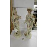 A good pair of Continental porcelain figures, 34 cm tall. (Something missing from the man's hand).