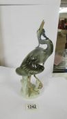 A Royal Dux figure of a heron with a fish in its mouth, in good condition.