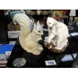 A Polar Bear and cub entitled 'Bear Hug' by Brooks and Bentley and a china squirrel made in Spain