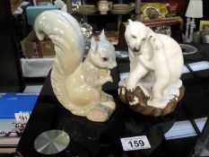 A Polar Bear and cub entitled 'Bear Hug' by Brooks and Bentley and a china squirrel made in Spain