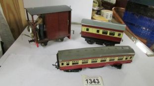 A tin plate railway carriage, a Triang railway carriage and a home built engine.