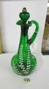 A green glass claret jug hand decorated with lily of the valley, 30cm< (a/f crack under handle).