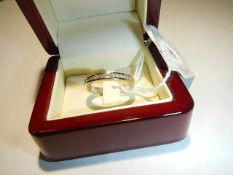 An 18ct gold wedding ring set diamonds, size O, 5 grams.