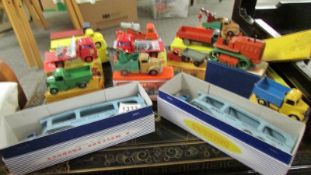 A selection of Playworn Dinky commercial vehicles in reproduction boxes.