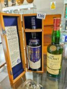 A boxed bottle of Royal Lochnagar single scotch and a bottle of Glenlivet single malt.