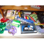 A mixed lot of new items including sellotape, gas lighters, travel clock, photo frame etc