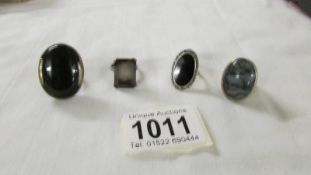 Four silver rings set large stones.
