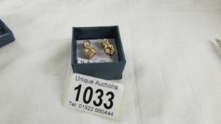 Two pairs of 9ct gold knot earrings.