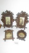 Four carved wood photograph frames.