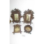 Four carved wood photograph frames.