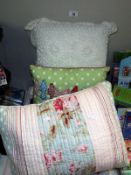 A throw with matching cushion, plus a purple throw and 2 other cushions