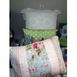 A throw with matching cushion, plus a purple throw and 2 other cushions