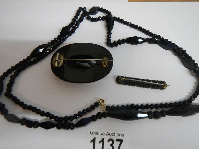Two black Whitby jet style brooches and a black necklace. - Image 5 of 5