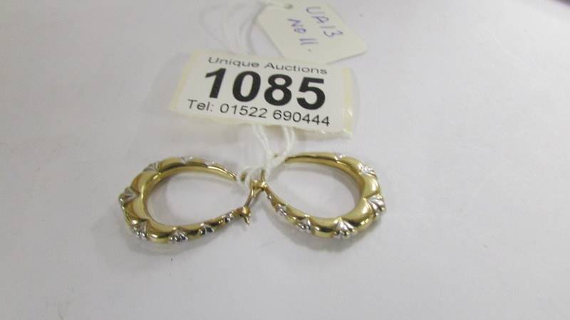 A pair of 9ct gold hoops in yellow and white gold, 1.4 grams.