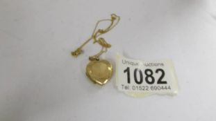 A 9ct gold heart shape locket with attached 9ct gold chain, 4.2 grams.