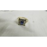 A square sapphire and diamond ring in yellow gold, size N half.