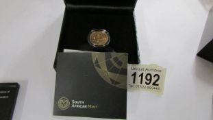 A boxed 50th anniversary gold proof quarter krugerand.