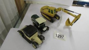 A Ruston Bucyrus German die cast digger and two model cars.