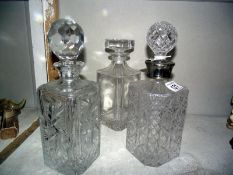 Three heavy cut glass decanters