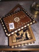 An inlaid box with chessboard incorporated, chess pieces included, missing 1 black pawn
