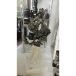 A contemporary metal figure on a marble base. COLLECT ONLY.